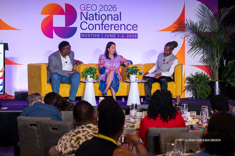 Rodney McKenzie, Jr., vice president of strategic partnerships at the Freedom Together Foundation (left), Angelique Power, president and CEO of The Skillman Foundation (center), and Marcus Walton, president and CEO of GEO (right), participate in the “Leading with Love” plenary at the GEO 2026 National Conference. The three sit in yellow armchairs onstage, with audience members in the foreground.